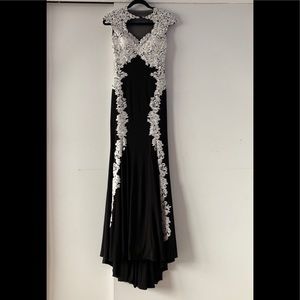 Form-fitted black dress with white lace